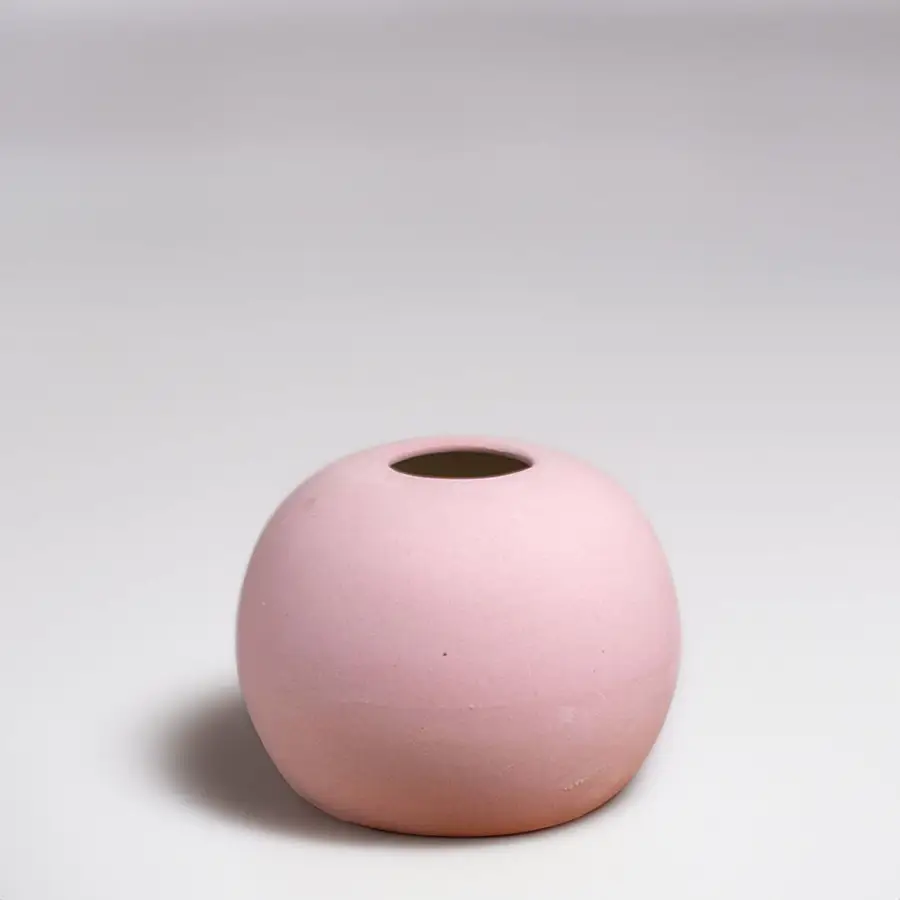 Pink ceramic decorative vase with rounded minimalist silhouette for elegant tabletop styling and modern home decor.