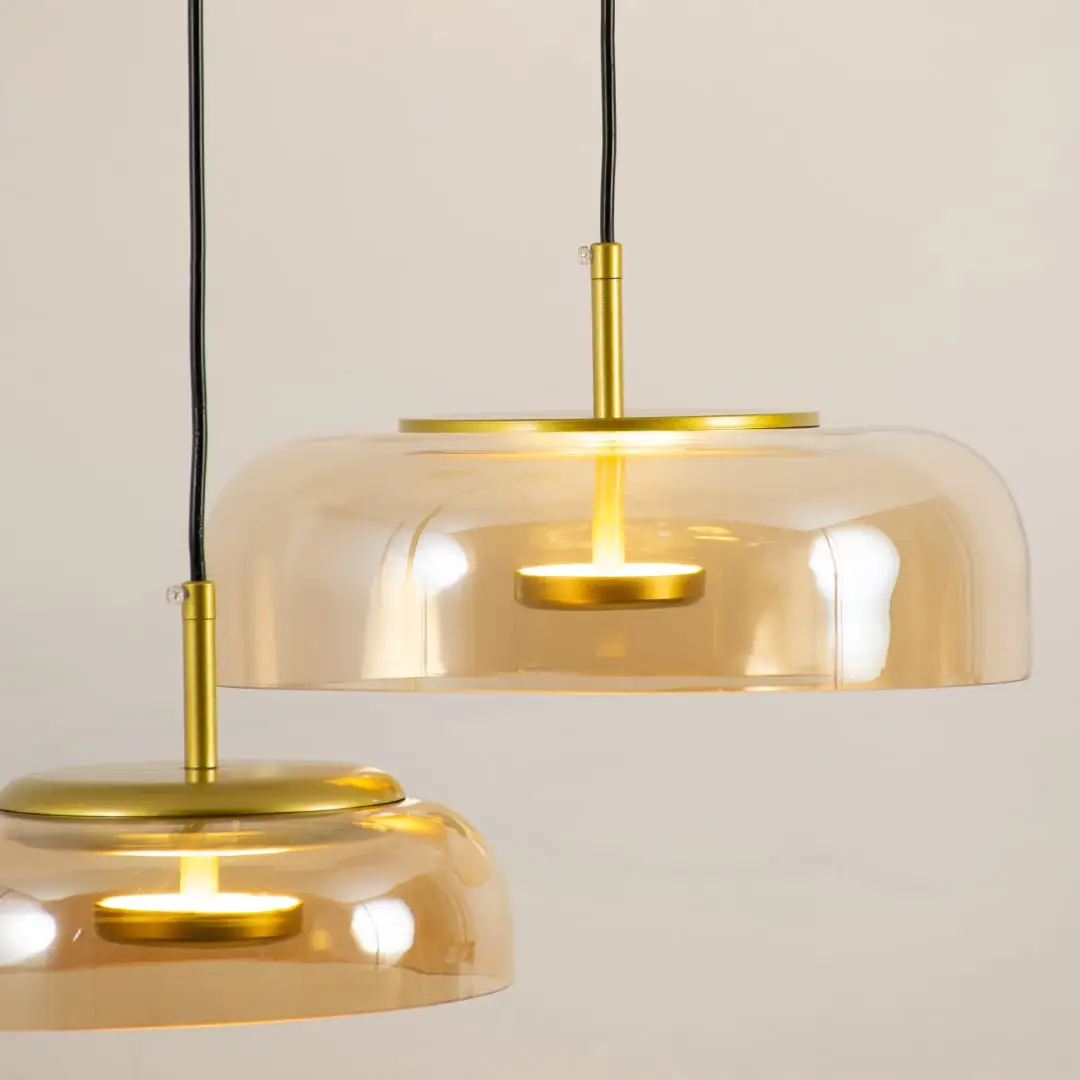 Amber glass pendant light closeup showcasing tinted glass finish and refined modern lighting craftsmanship details.