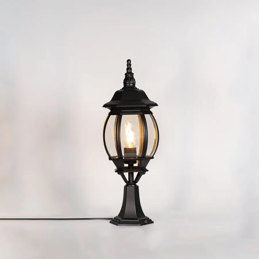 Classic black outdoor gate light with warm glowing bulb for stylish exterior decor styling use.