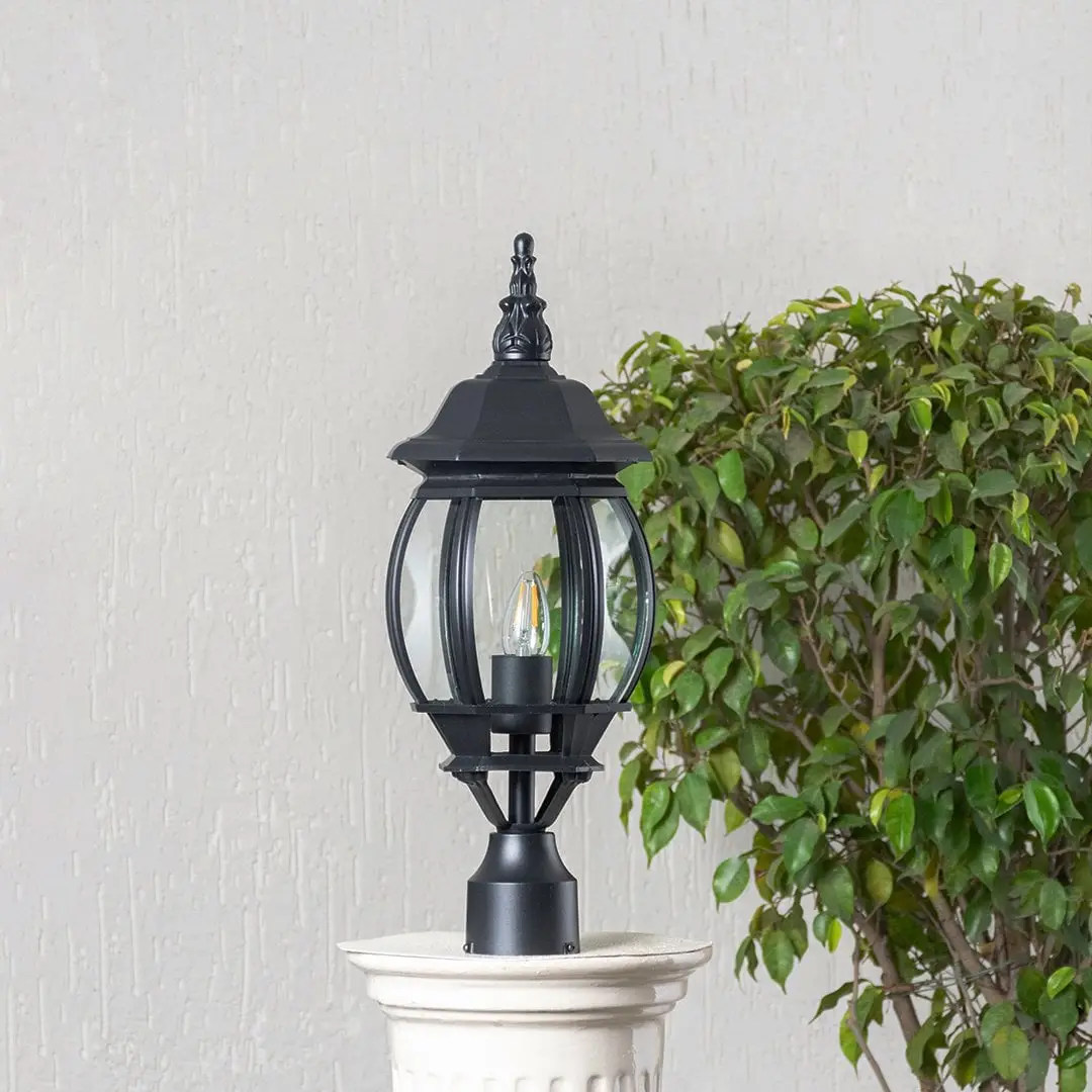 Classic black outdoor pillar lamp with clear curved glass shade placed on stone pillar ideal for entrance and garden.