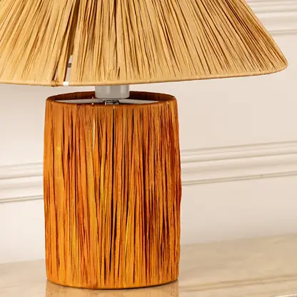 Woven natural fiber lamp shade with handcrafted wooden base highlighting rich texture and artisan craftsmanship.