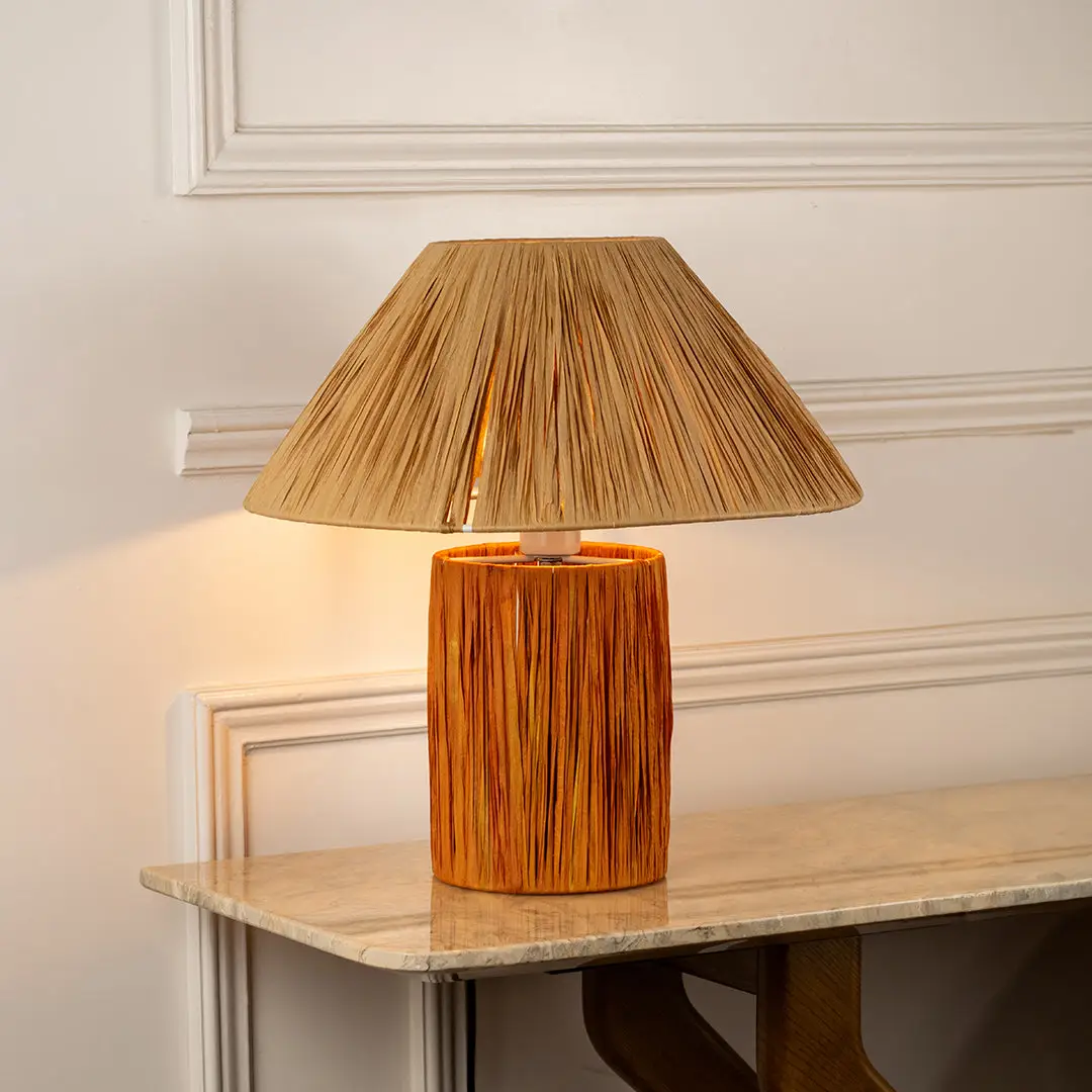 Table lamp with woven shade and textured base perfect for rustic bedroom or living room table decor styling on clean background.