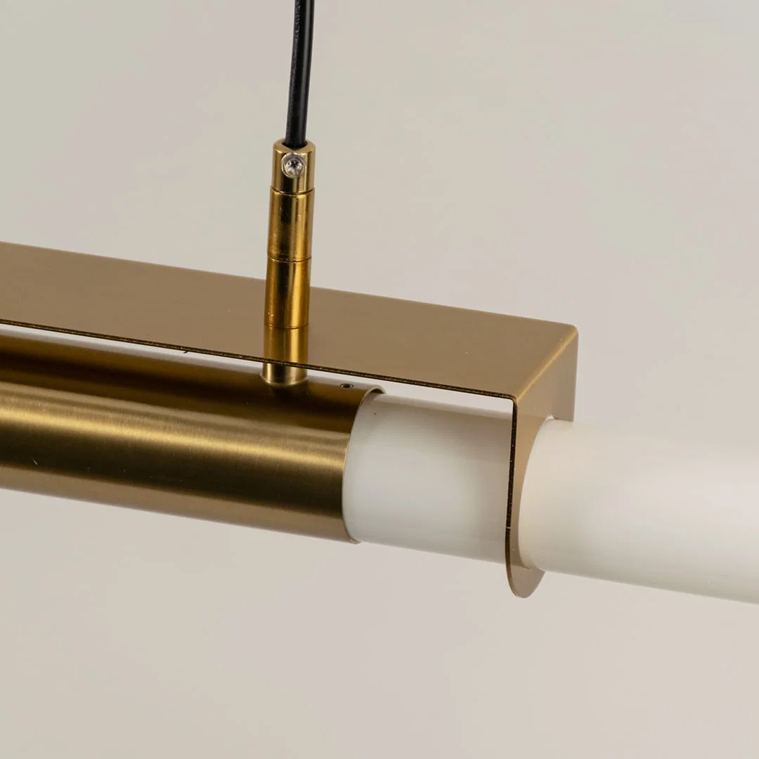Gold metal linear LED pendant light showcasing premium craftsmanship and frosted diffuser detailing for modern interiors.