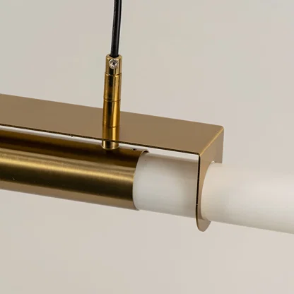 Gold metal linear LED pendant light showcasing premium craftsmanship and frosted diffuser detailing for modern interiors.