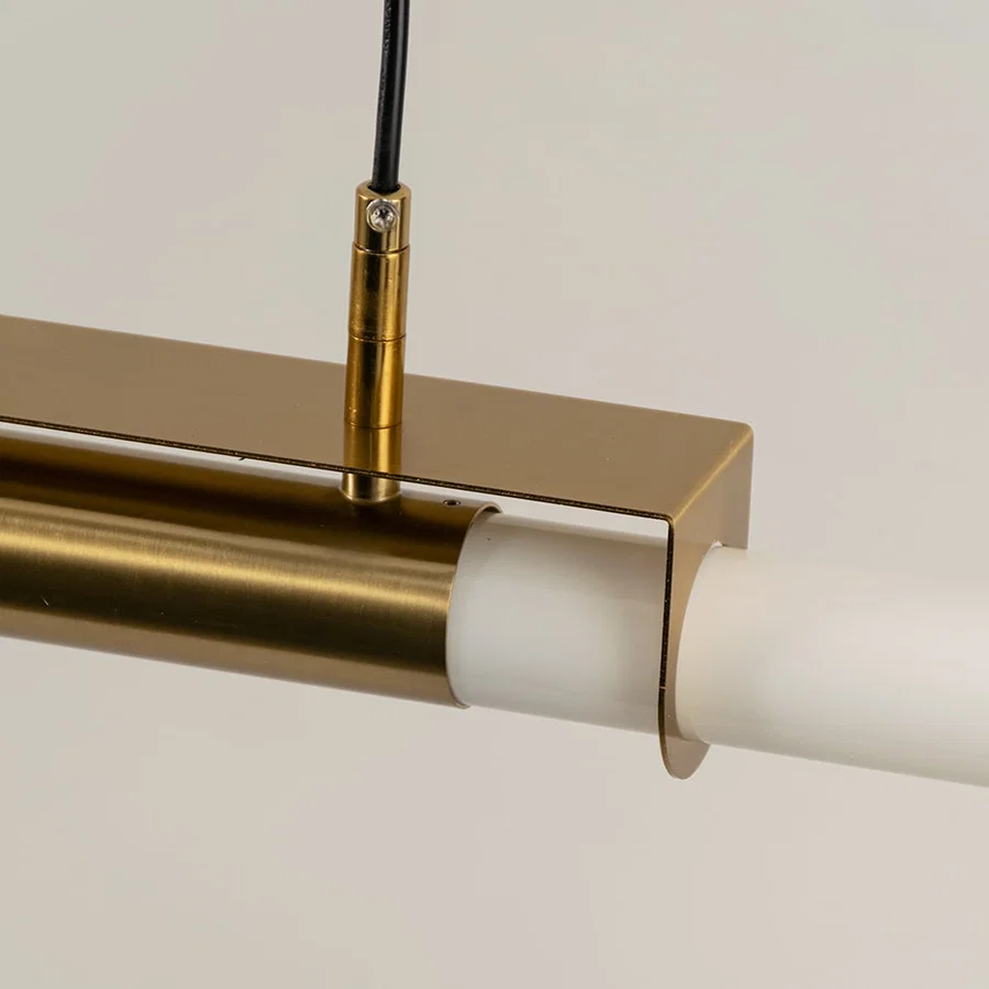 Gold metal linear LED pendant light showcasing premium craftsmanship and frosted diffuser detailing for modern interiors.