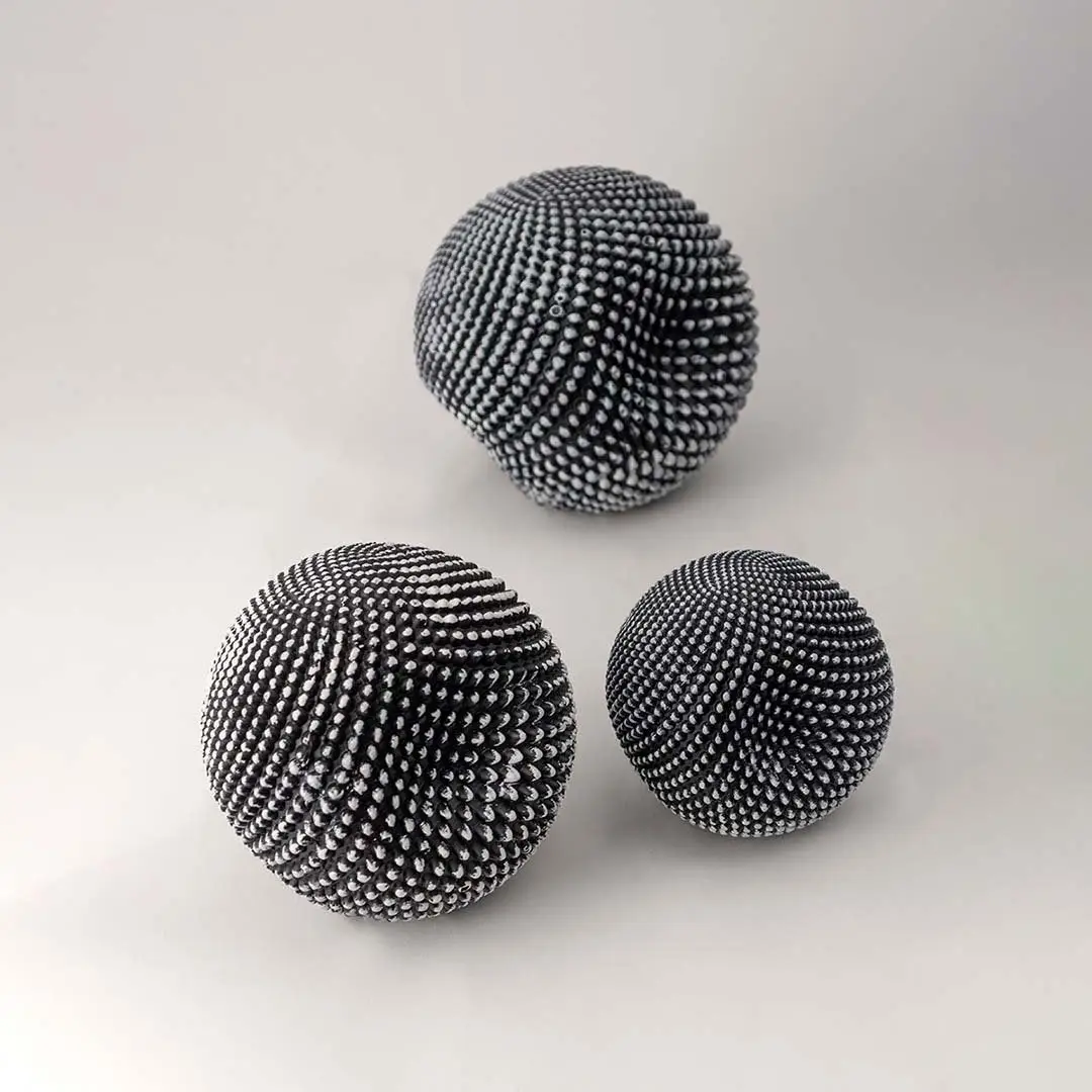 Set of black textured decorative spheres for elegant shelf styling and contemporary tabletop home decor displays.