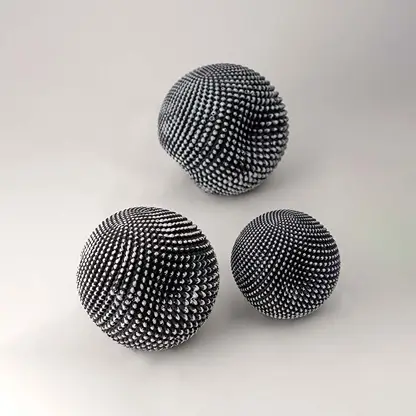 Set of black textured decorative spheres for elegant shelf styling and contemporary tabletop home decor displays.
