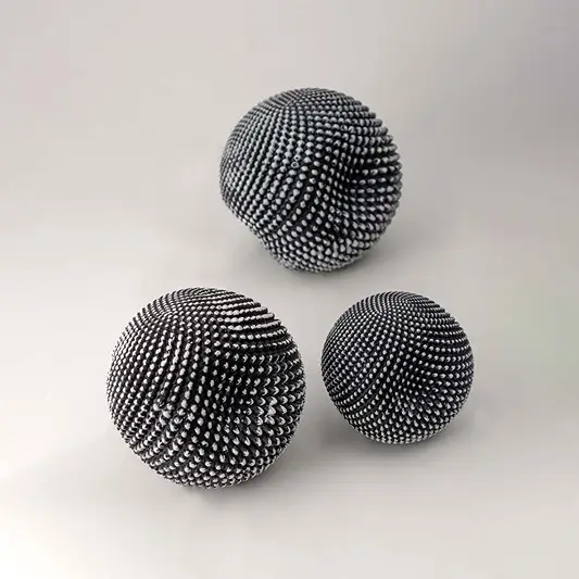 Set of black textured decorative spheres for elegant shelf styling and contemporary tabletop home decor displays.