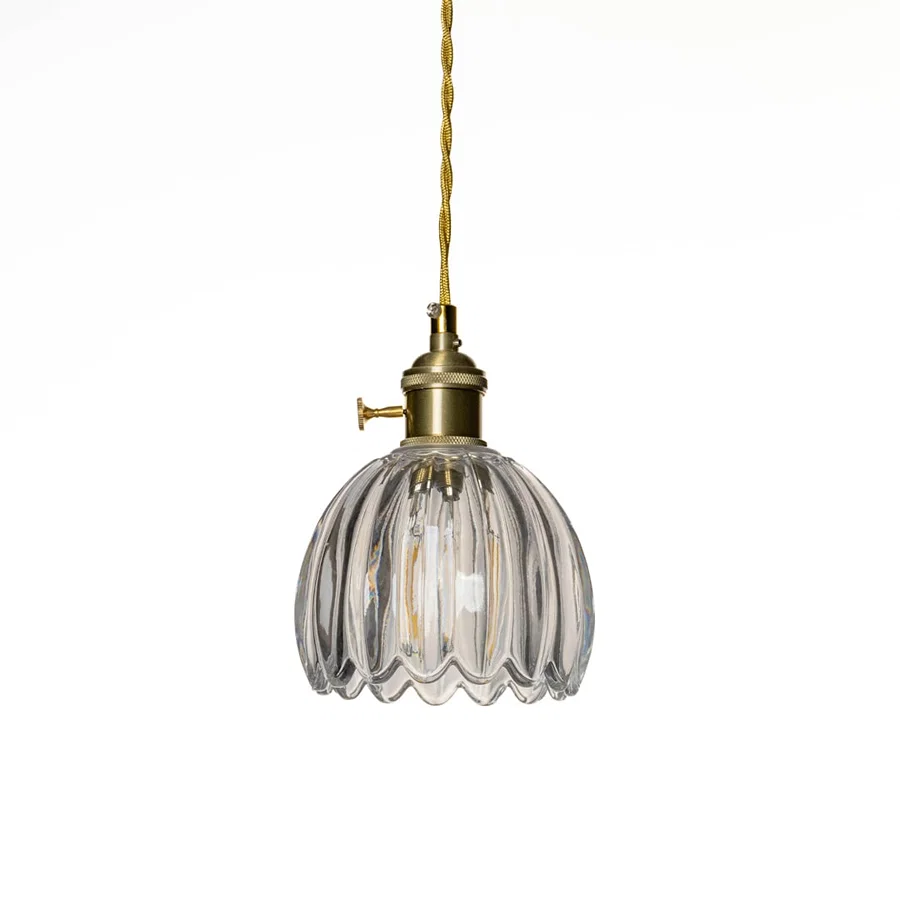 Clear ribbed glass pendant light with polished gold fittings designed for elegant modern spaces.