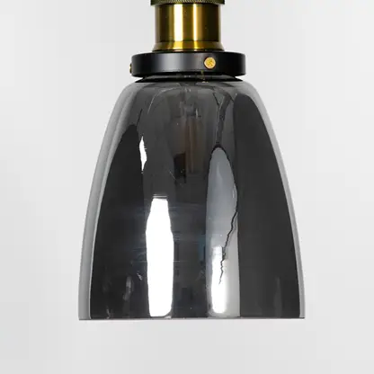 Smoked glass pendant light with brass metal fixture showcasing glossy finish and contemporary lighting style.