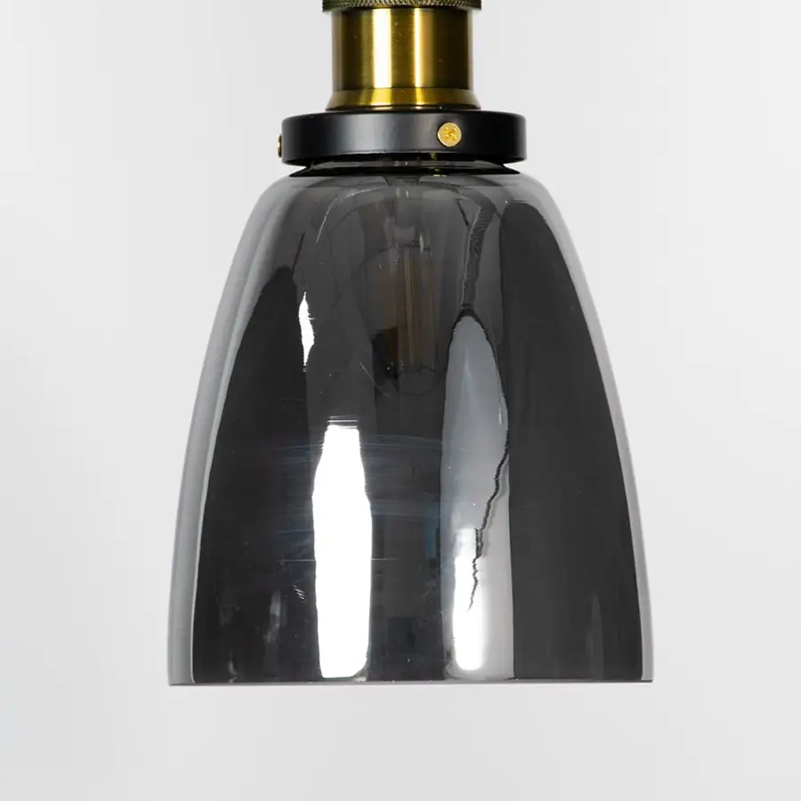 Smoked glass pendant light with brass metal fixture showcasing glossy finish and contemporary lighting style.