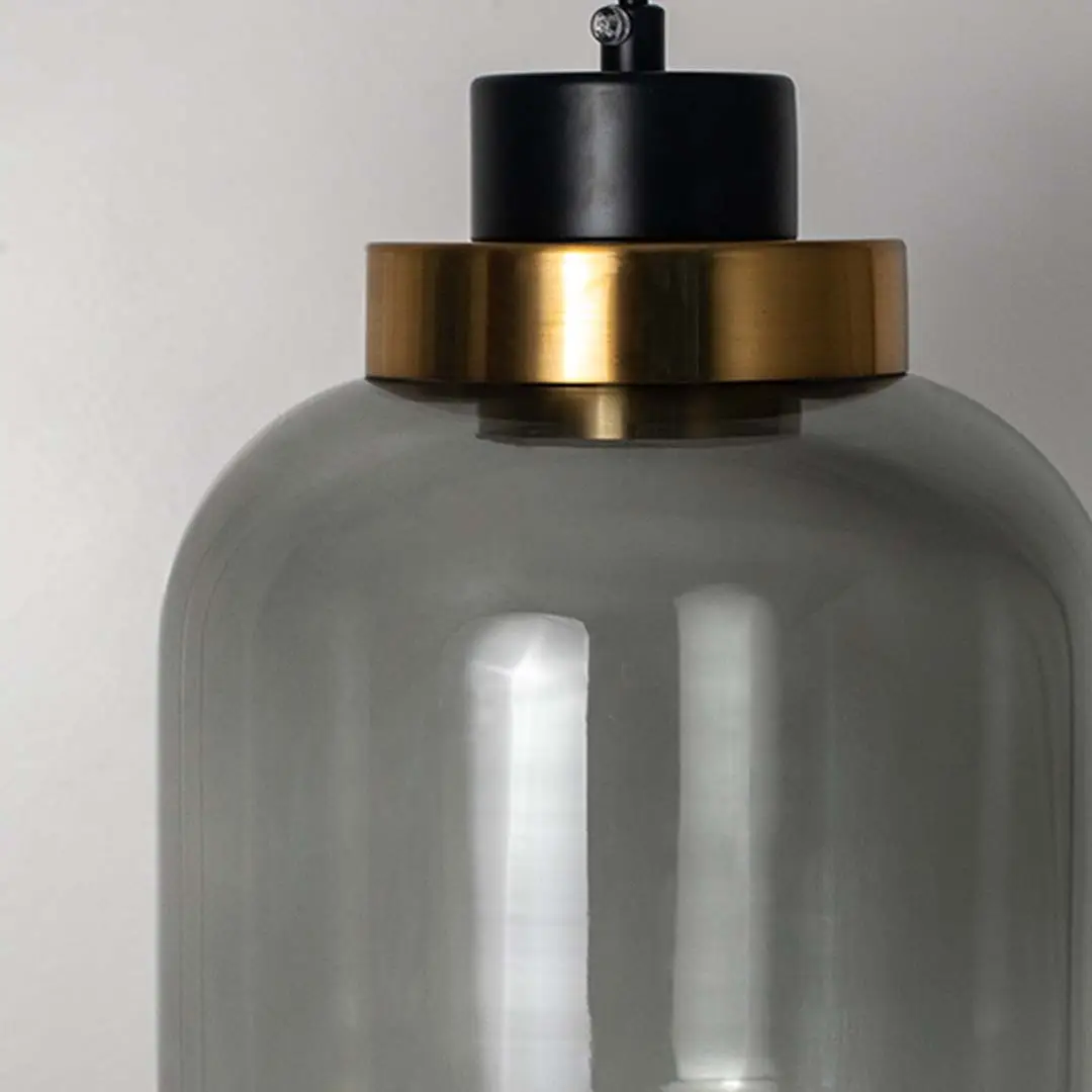 Detailed view of smoky glass pendant light with black and gold fittings highlighting premium design.