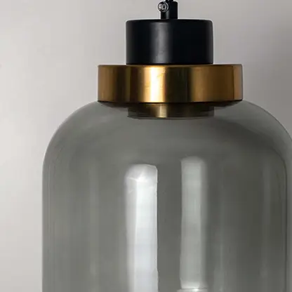 Detailed view of smoky glass pendant light with black and gold fittings highlighting premium design.