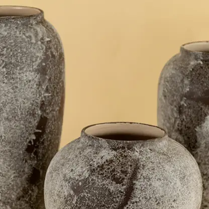 Artistic round ceramic vase in rustic grey brown stone look finish crafted for elegant home decorative accents.