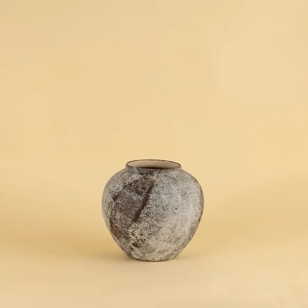 Round rustic ceramic vase with grey and brown textured finish ideal for modern and traditional interiors.