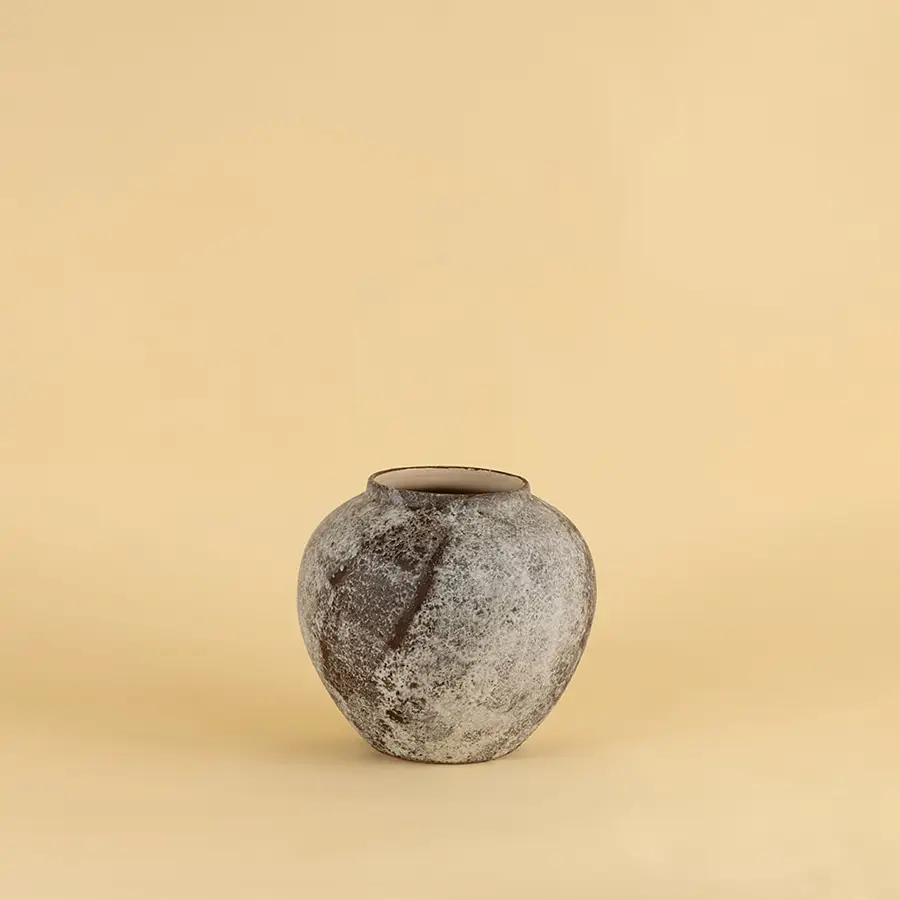 Round rustic ceramic vase with grey and brown textured finish ideal for modern and traditional interiors.
