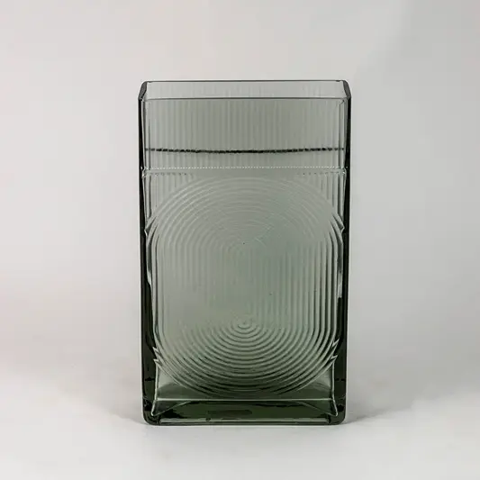 Smoky gray decorative glass vase with embossed circular pattern and glossy finish shown on clean white backdrop.