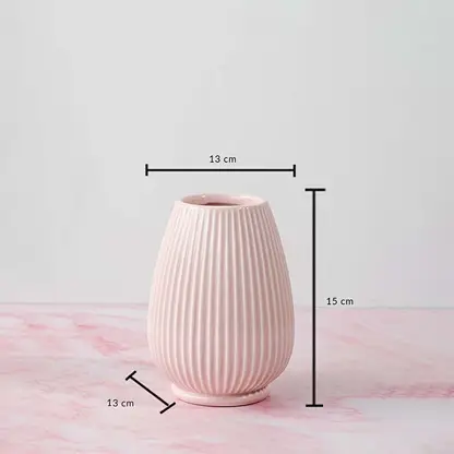 Pink ceramic vase with height 15 cm and width 13 cm shown on a pink marble surface for size reference.