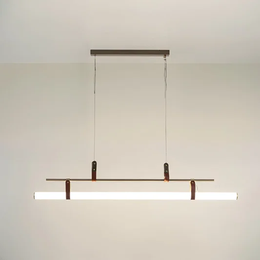 Black metal linear LED pendant light with integrated illumination creating sleek modern ambient ceiling lighting indoors.