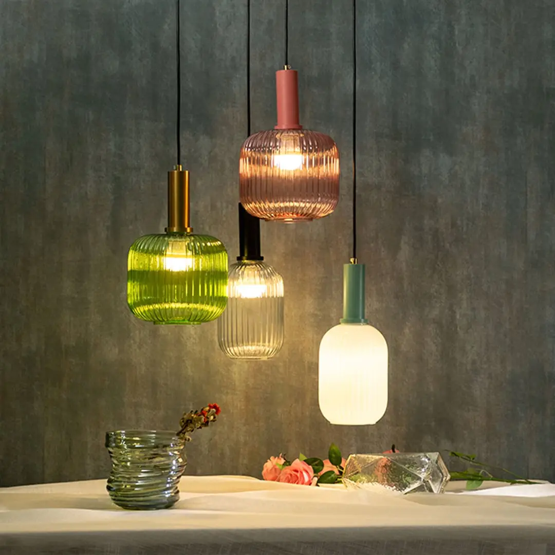 Mixed glass pendant lights with brass finish creating stylish ambient lighting for contemporary interiors.