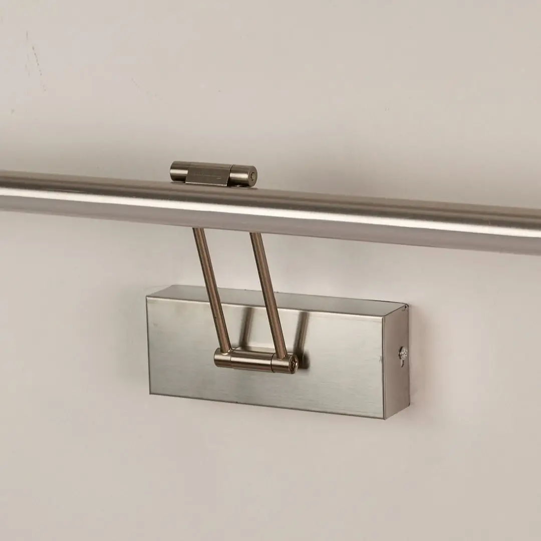 Closeup view of silver picture light highlighting smooth metal body and adjustable arm for focused picture and wall lighting.