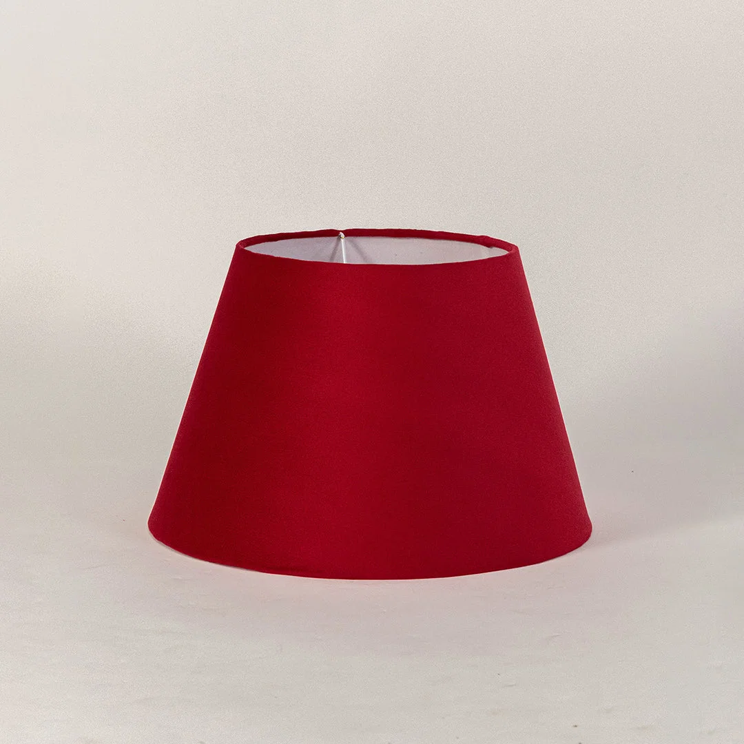 Minimal fabric lampshade in red finish for table or floor lamp soft lighting and home decor placement white background.