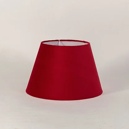 Minimal fabric lampshade in red finish for table or floor lamp soft lighting and home decor placement white background.