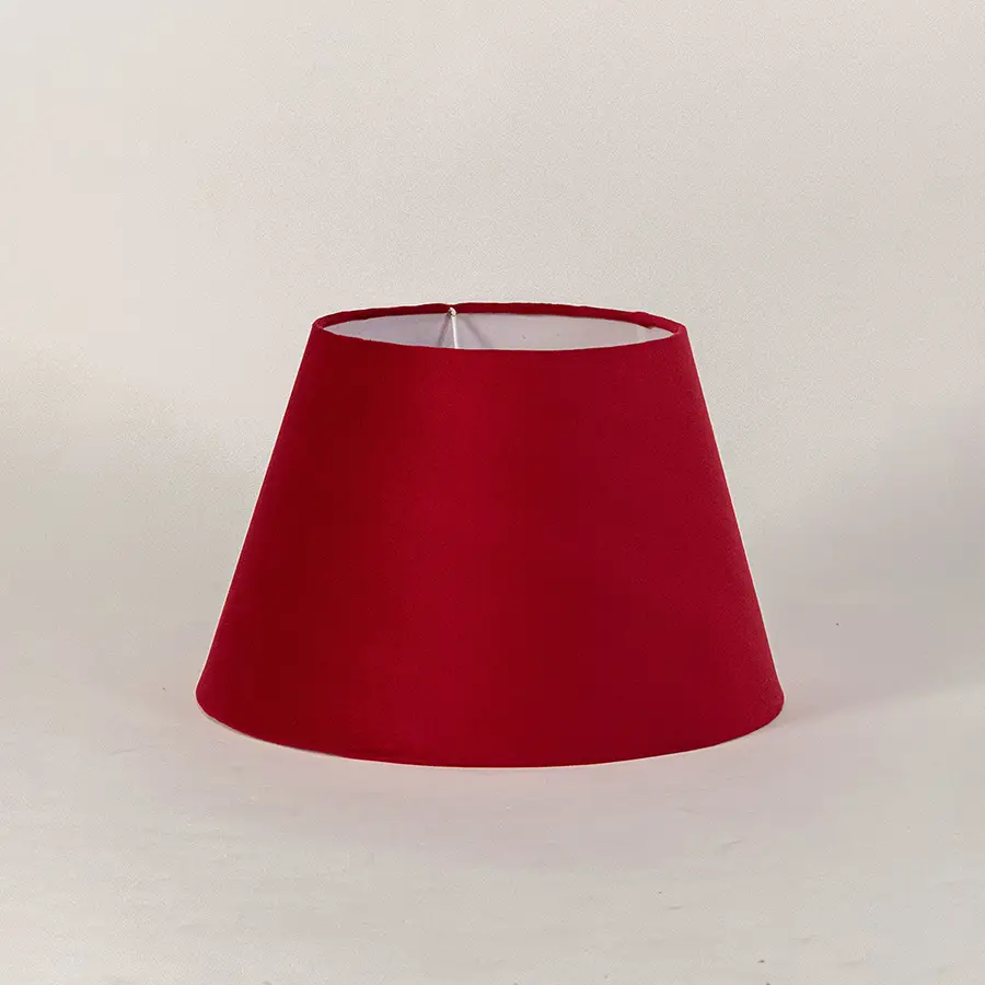 Minimal fabric lampshade in red finish for table or floor lamp soft lighting and home decor placement white background.