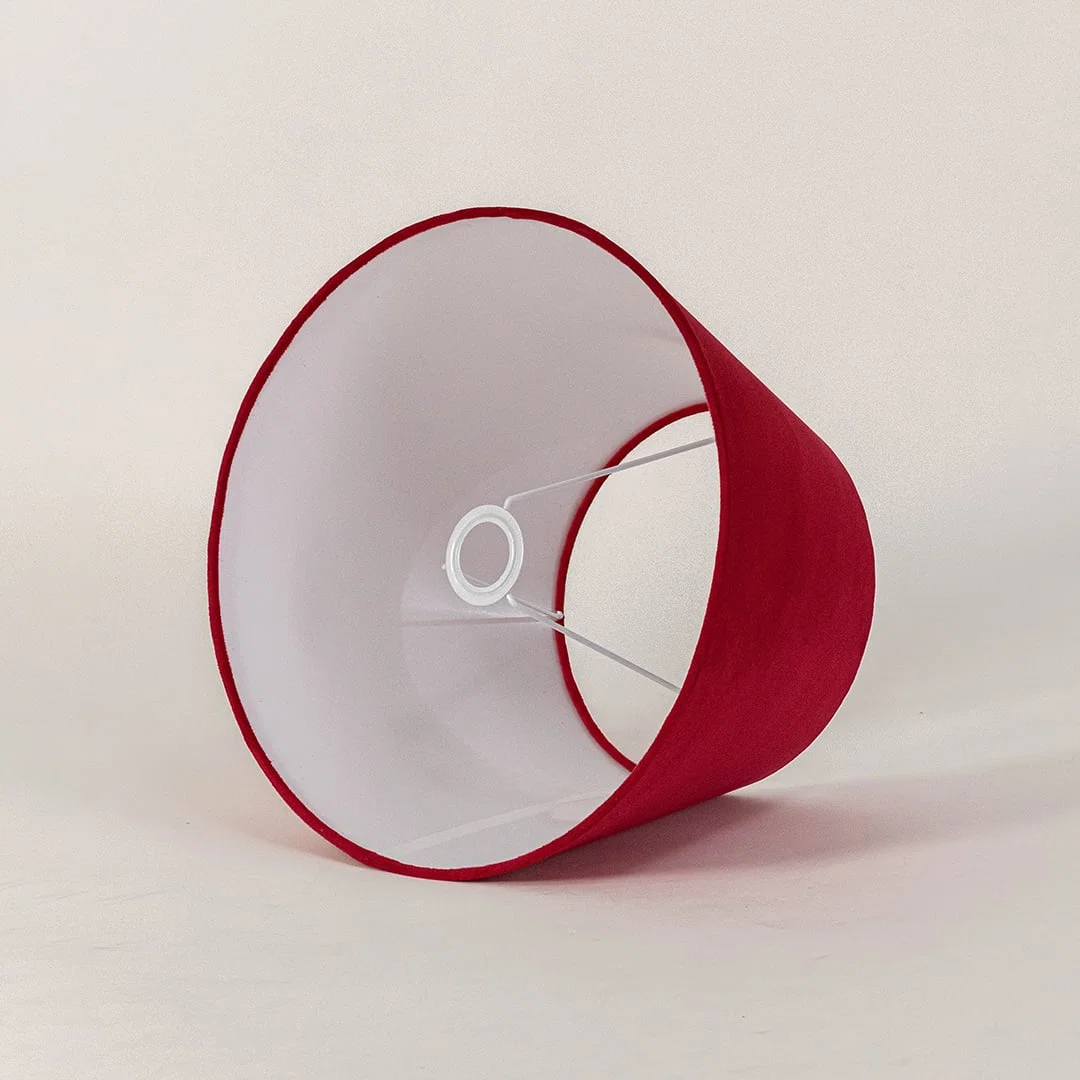 Red tapered lampshade displayed on a clean white background highlighting its smooth fabric texture and wide shape for modern lighting.