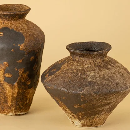 Detailed view of rustic brown ceramic vase highlighting unique handmade texture and natural earthy surface tone.