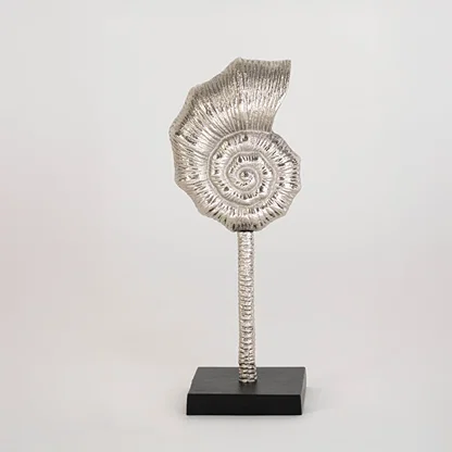 Decorative silver spiral sculpture on a black stand displayed against a clean white background showing its textured artistic design