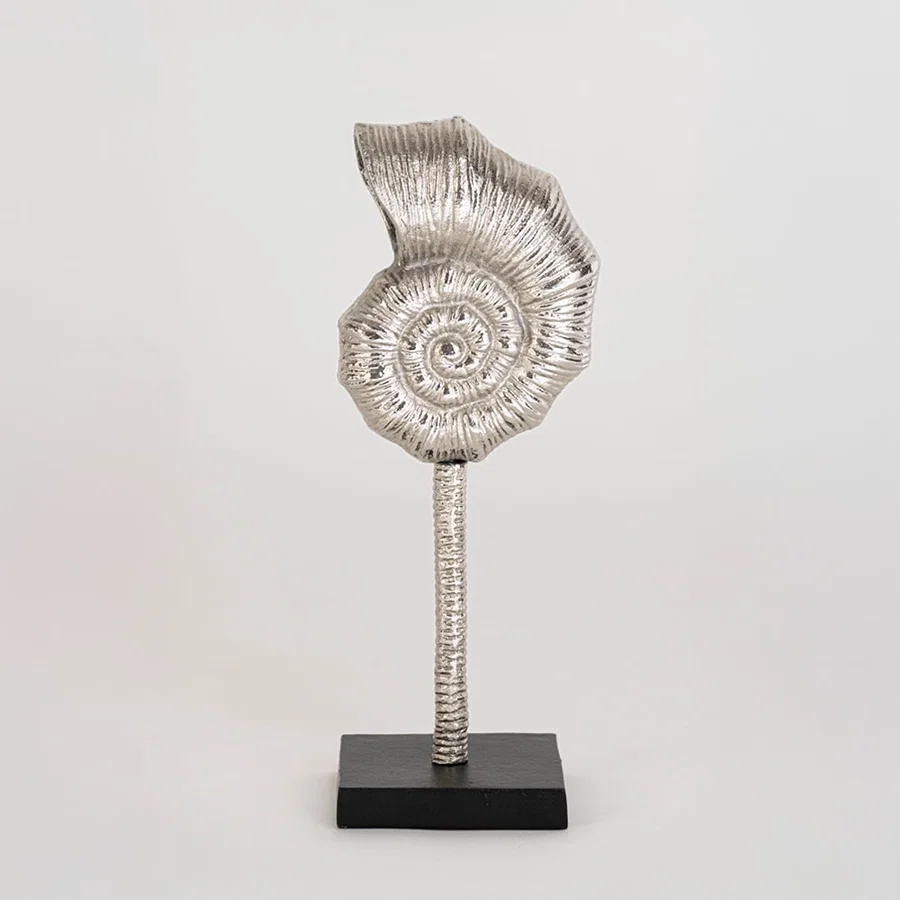 Modern silver swirl accent piece on a sturdy black base photographed on a white background highlighting its elegant handcrafted finish