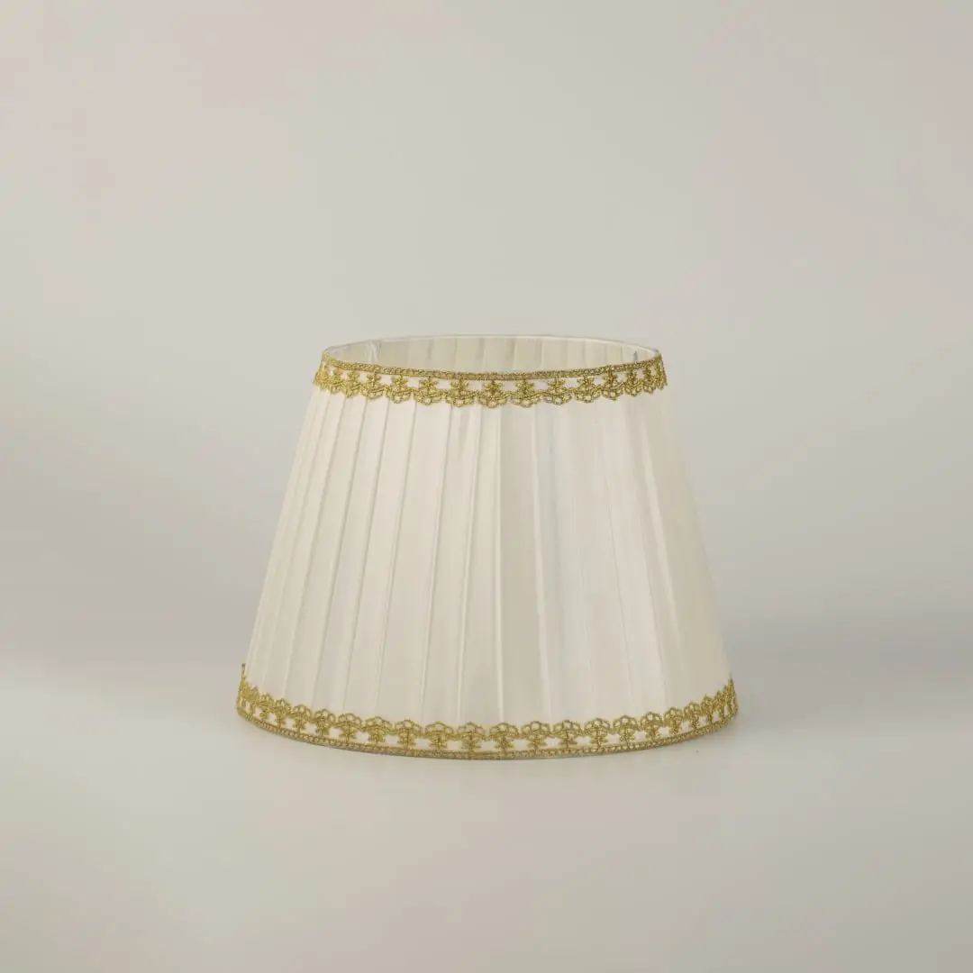 Table lamp with green metal base and pleated white shade presented on a clean white background for clear product detail.
