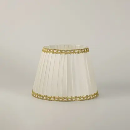 Table lamp with green metal base and pleated white shade presented on a clean white background for clear product detail.
