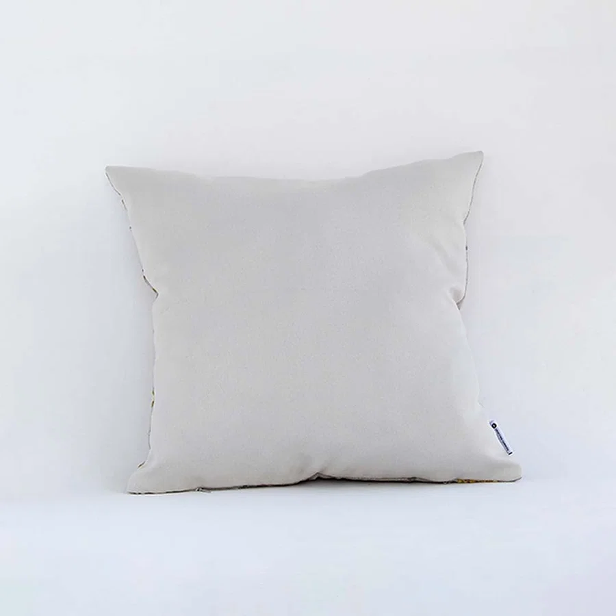 Side view of the floral cushion displaying its plump filled shape and elegant embroidered pattern.