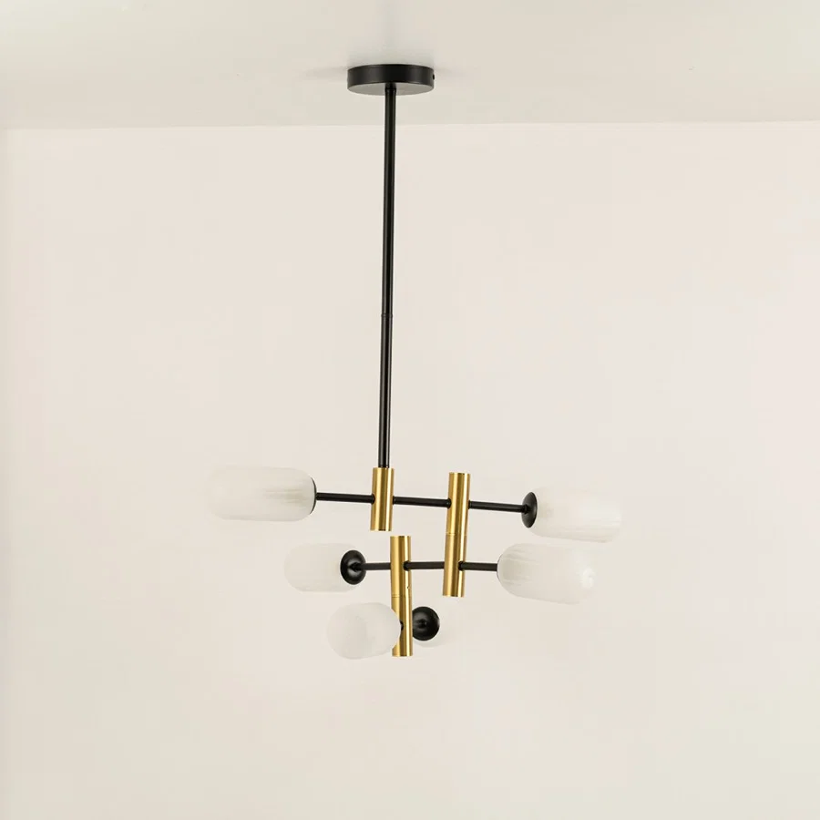 Gold and black metal chandelier with frosted glass tube shades designed for stylish modern ceiling lighting indoors.