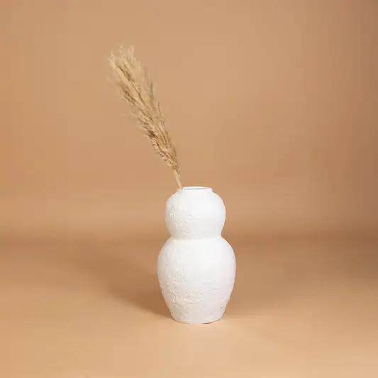 White textured decorative vase placed in a curated interior setting enhancing shelves consoles and living spaces with natural artistic decor.