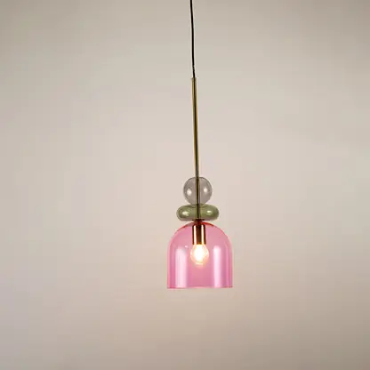Green and pink glass pendant light illuminated to display stylish hanging light design with soft ambient glow.