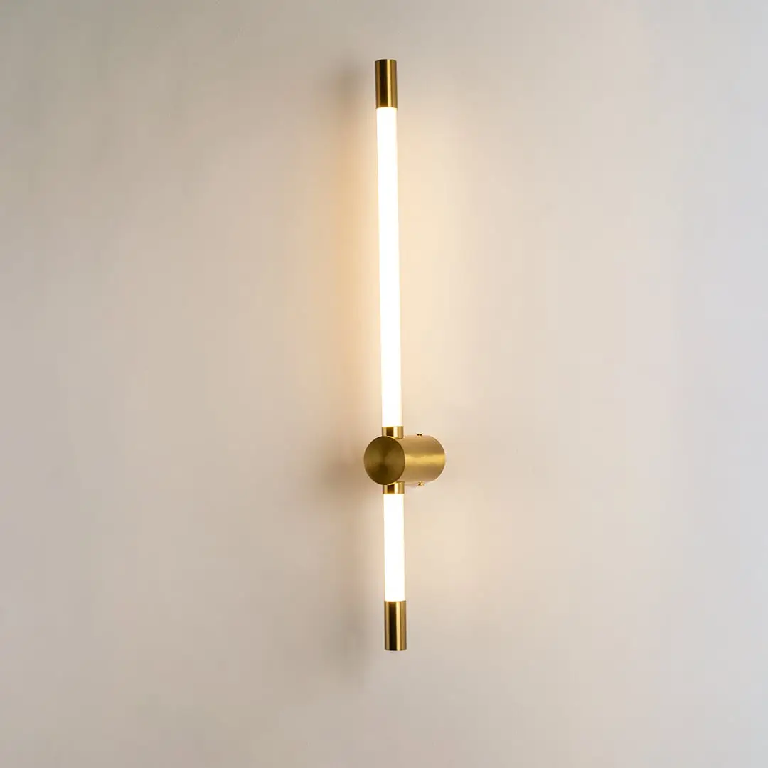 Modern gold LED wall light with warm ambient glow for elegant bedroom and luxury decor styling spaces.

