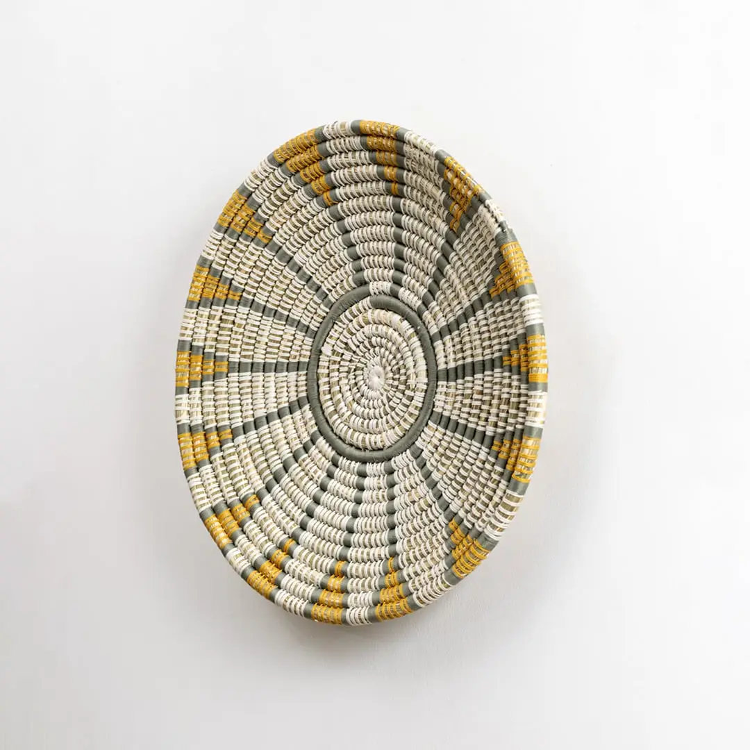 Handwoven wall plate viewed from the side showing its textured depth and woven craftsmanship designed to add natural character to interior walls.