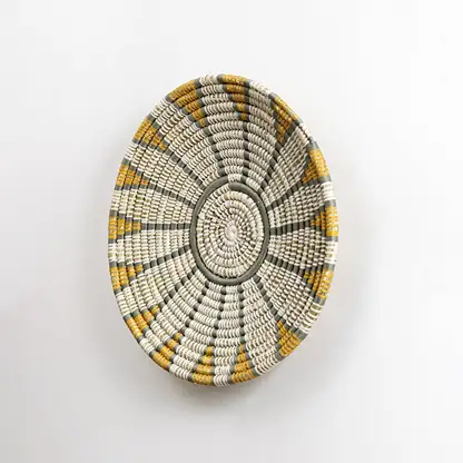 Handwoven wall plate viewed from the side showing its textured depth and woven craftsmanship designed to add natural character to interior walls.