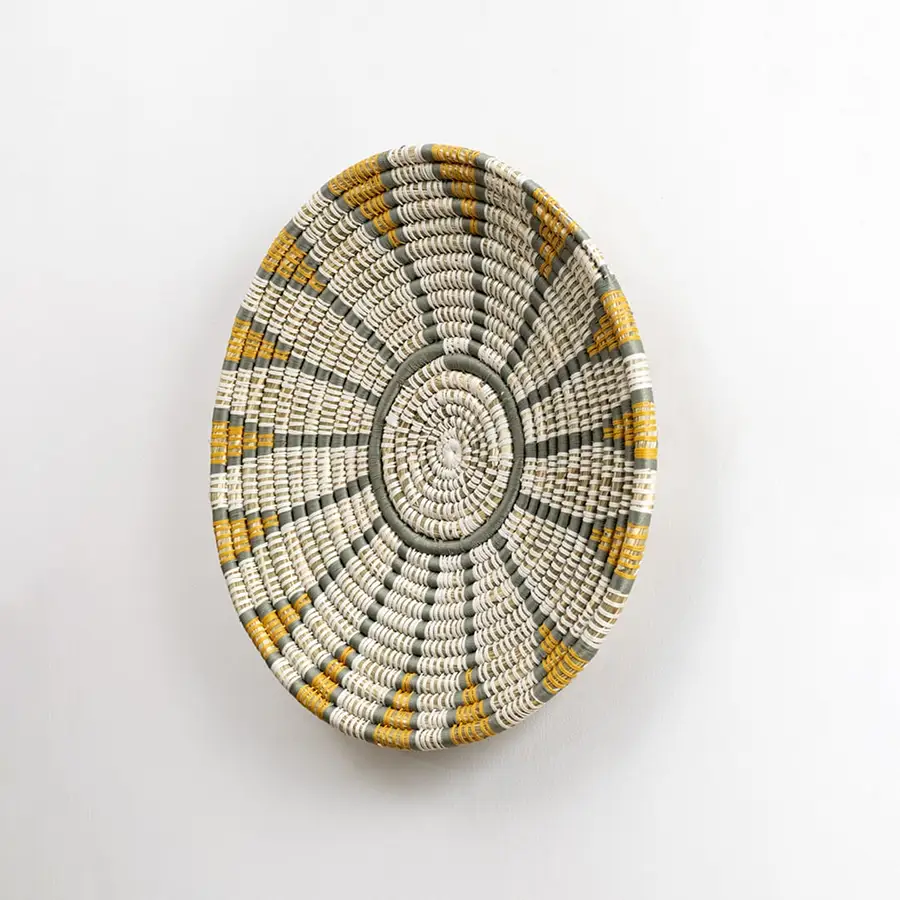 Handwoven wall plate viewed from the side showing its textured depth and woven craftsmanship designed to add natural character to interior walls.