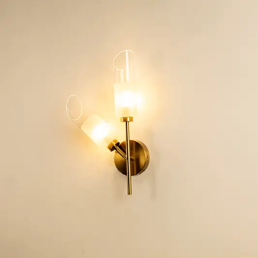 Modern gold metal wall light with clear glass shade for elegant hallway and luxury decor styling spaces.