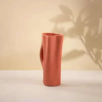 Terracotta ceramic decorative vase with sculptural silhouette for contemporary tabletop styling and modern home decor.