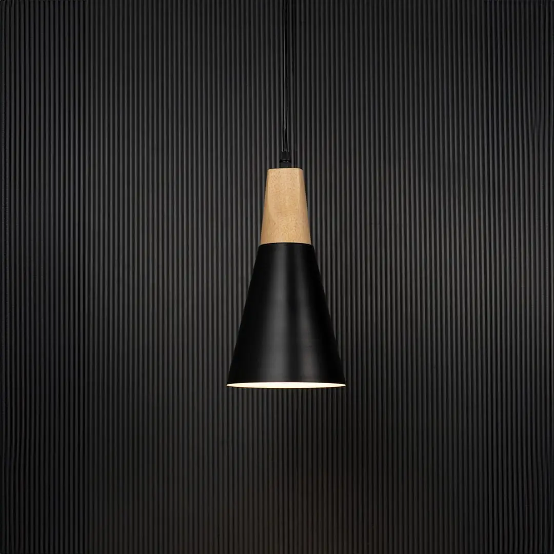 Black metal pendant light with wooden top and conical shade glowing on black background for modern home interiors.