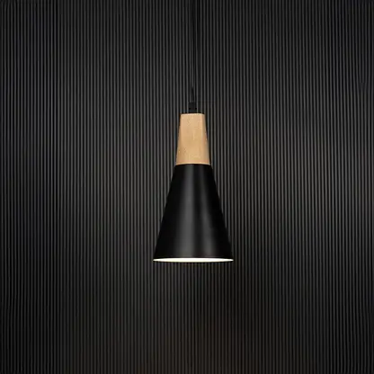 Black metal pendant light with wooden top and conical shade glowing on black background for modern home interiors.