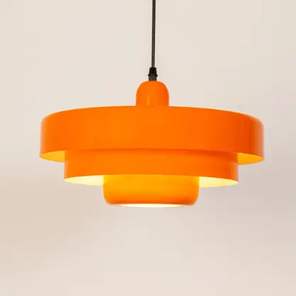 Orange metal pendant light with layered shade design for kitchen island dining room and modern ceiling lighting.