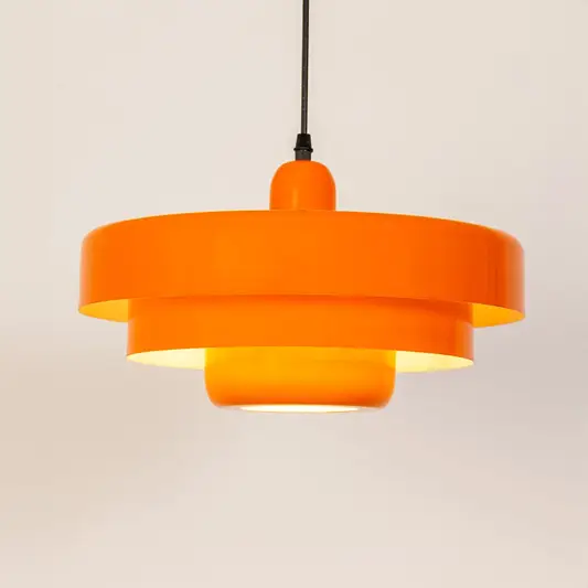 Orange metal pendant light with layered shade design for kitchen island dining room and modern ceiling lighting.