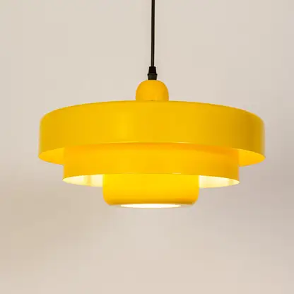 Modern pendant light in yellow metal finish with layered shade for kitchen or dining decor lighting white background.