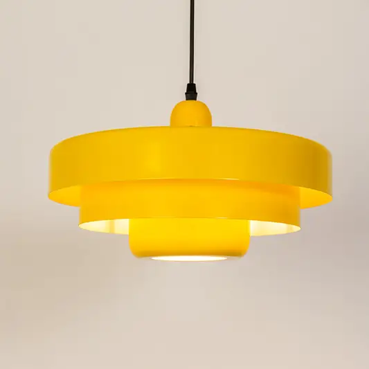 Modern pendant light in yellow metal finish with layered shade for kitchen or dining decor lighting white background.
